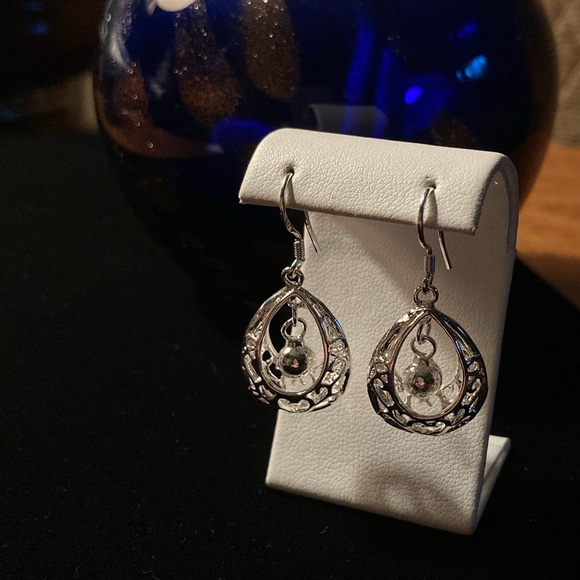 Water drop in a cage. Silver plated wired hook earrings